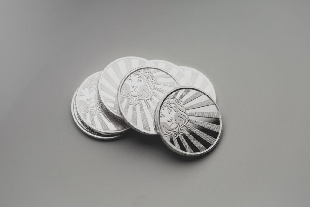 A pile of silver-colored coins.