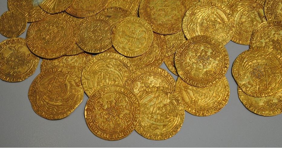 Several ancient coins of gold metal are on display