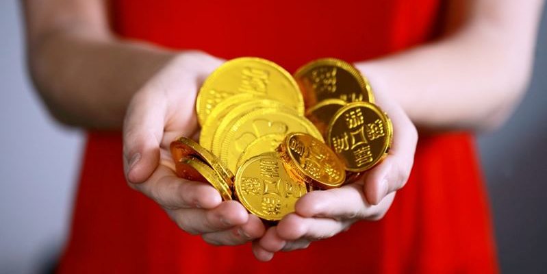 Gold coins in a person’s hands