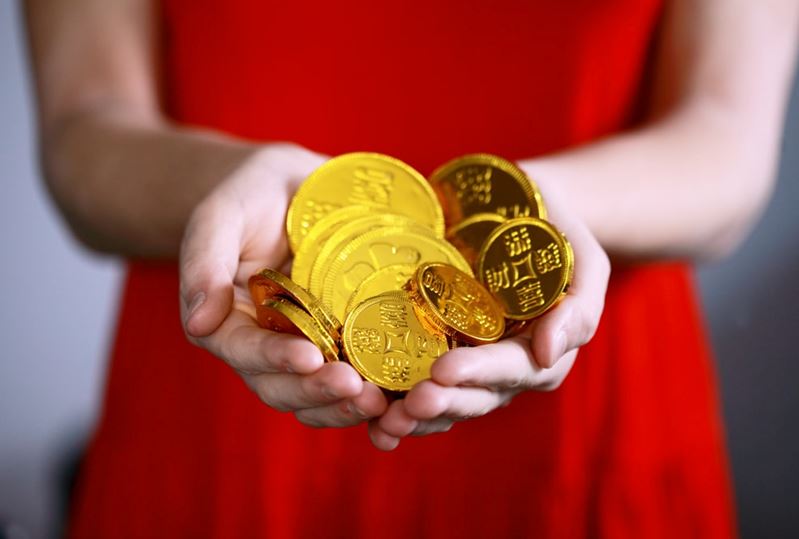 Gold coins in a person’s hands