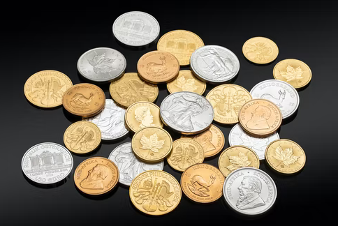 Gold and silver coins on a black surface