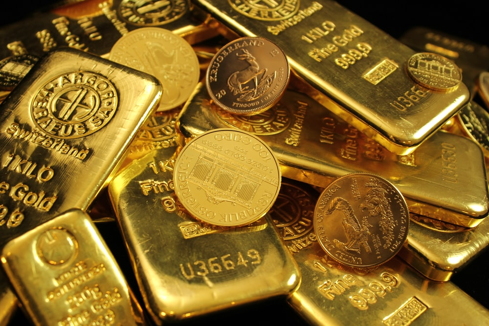 A close up of gold bullion bars and bullion coins