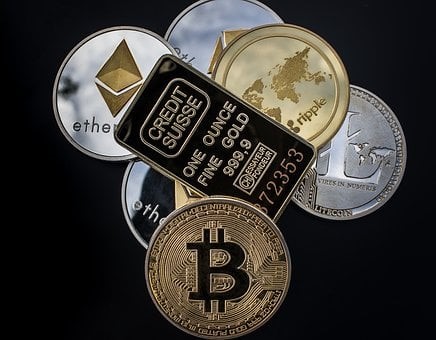 Picture of gold bar and various cryptocurrencies