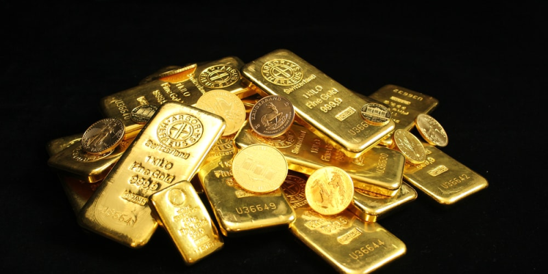 Gold bullion bars and coins stacked on each other