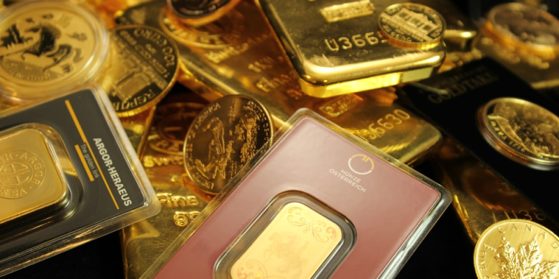 A close up of gold bullion bars, coins, and gold chips