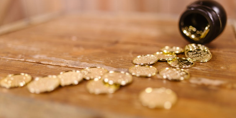 Gold coins falling from a jar