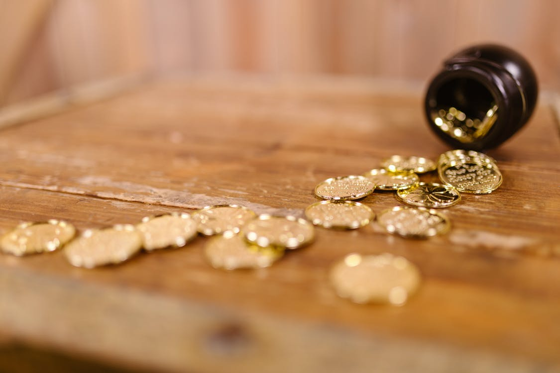 Gold coins falling from a jar