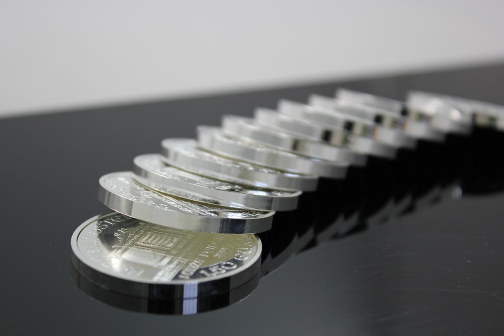 Silver coins laid out on a desk