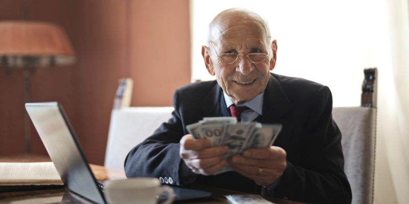 A senior citizen holding IRA withdrawal amount