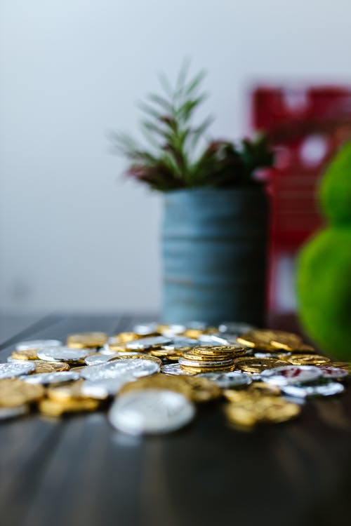 A pile of gold and silver coins placed on a table
