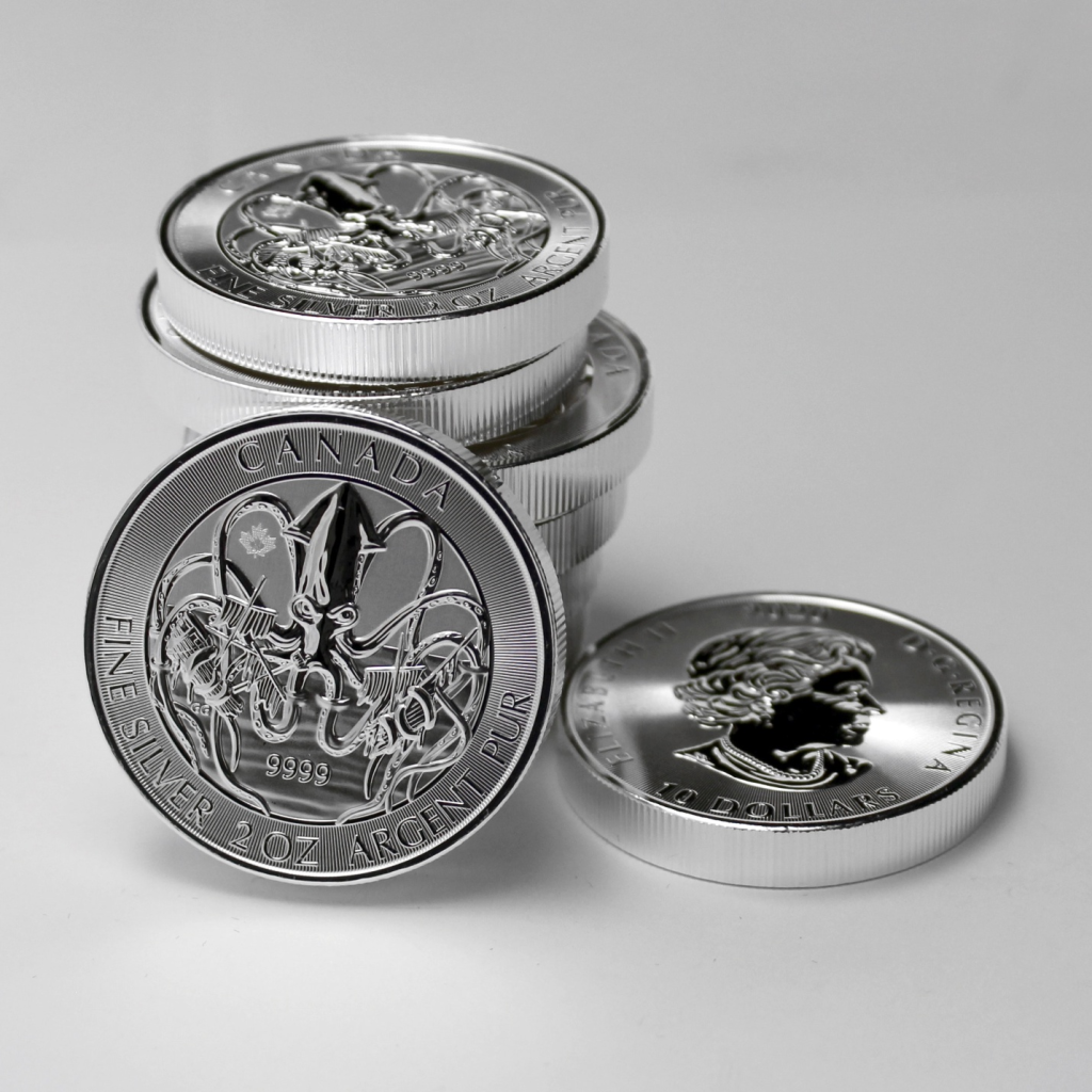 A couple of silver coins stacked on to each other.