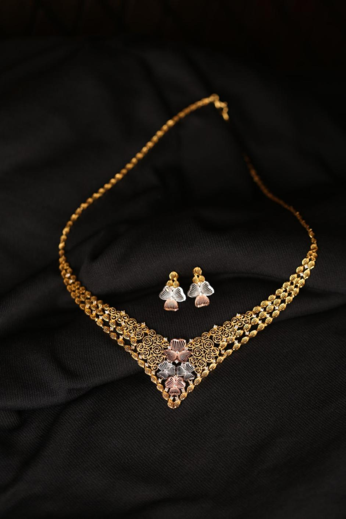 Gold jewelry on a black surface.