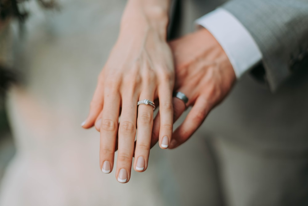 Beautiful wedding rings worn by a couple