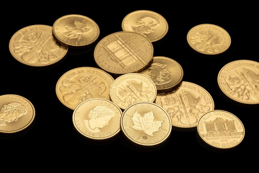some gold coins shot in a black backdrop