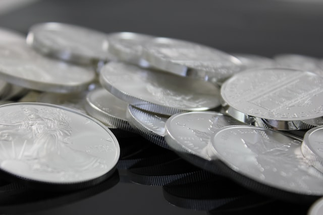 A bunch of Silver coins placed on a table