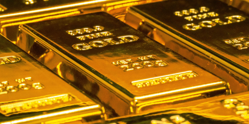 A close up of stacked two hundred gram gold bullion bars