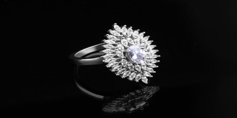 A diamond studded platinum ring against a black background