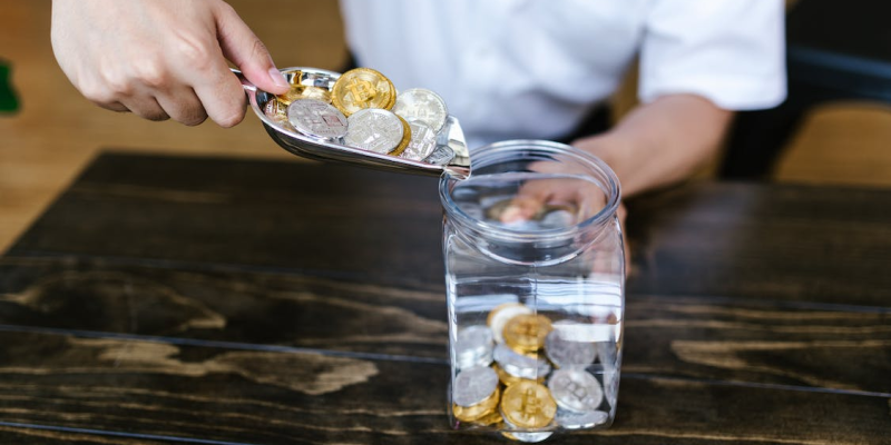 Gold and silver coins in a jar