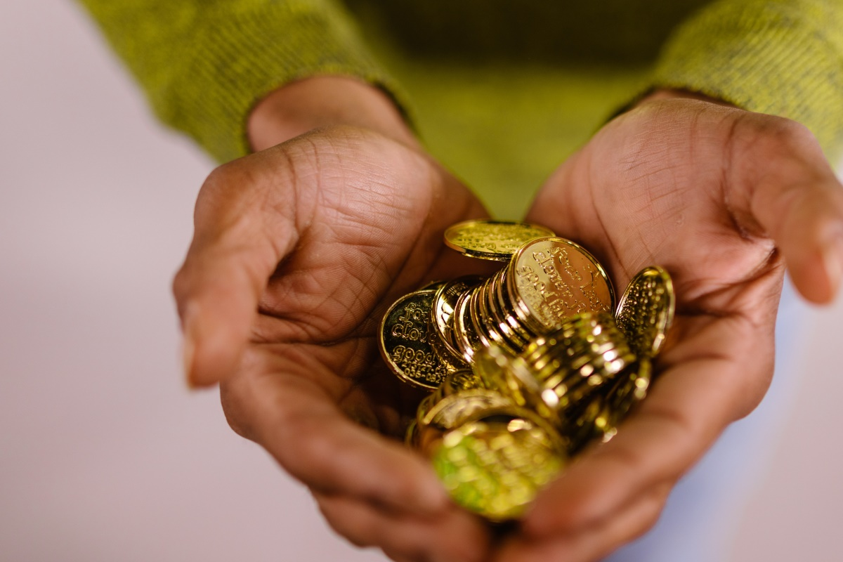 A person holding gold coins