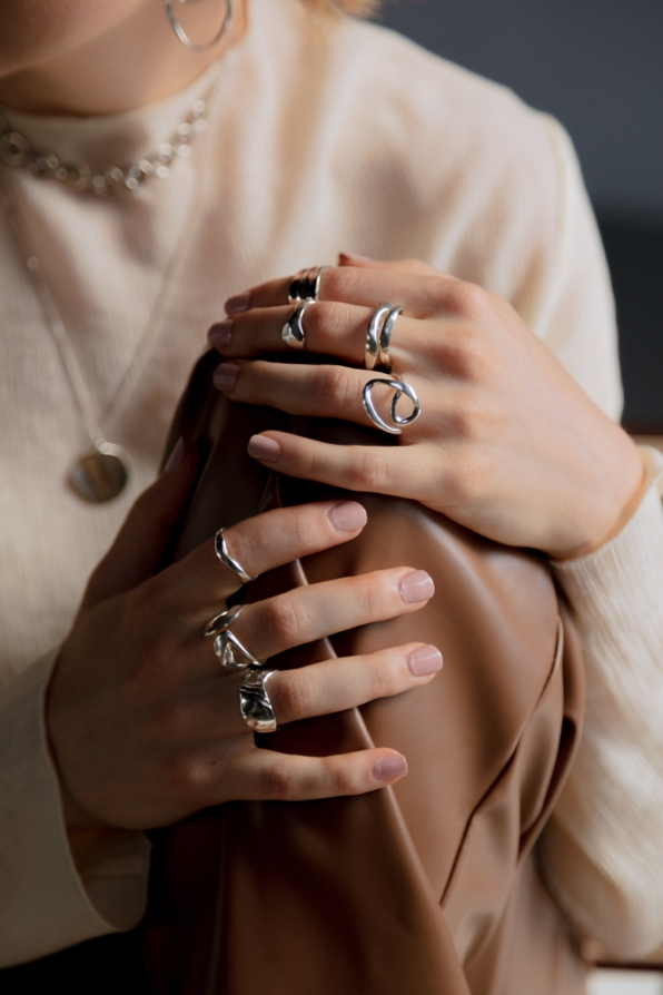 Silver rings on both hands.
