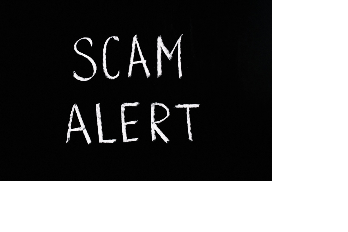 The words "scam alert" are spelled on a dark background.