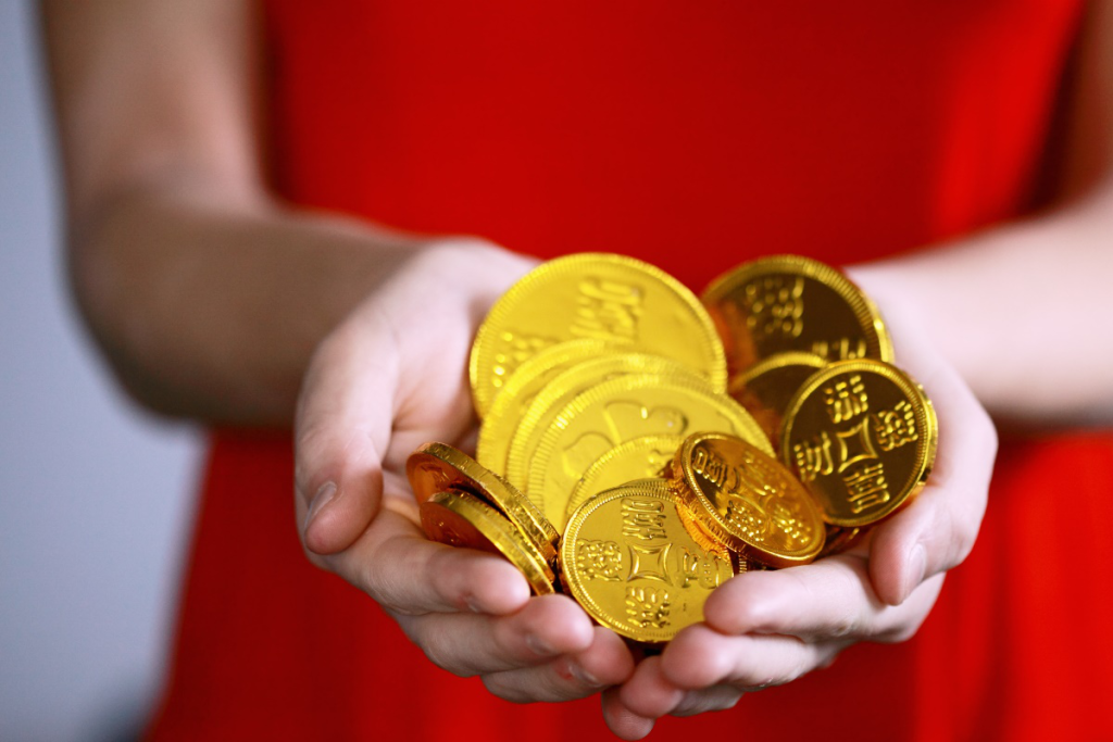 Person holding gold coins in hands