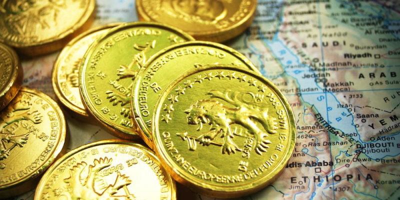 various gold coins on top of a map.