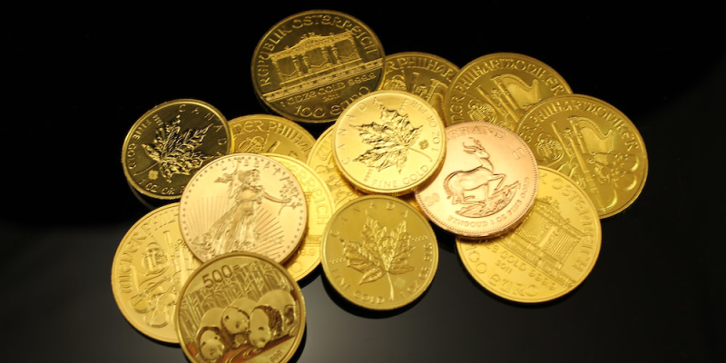 a stack of gold coins from various mints.